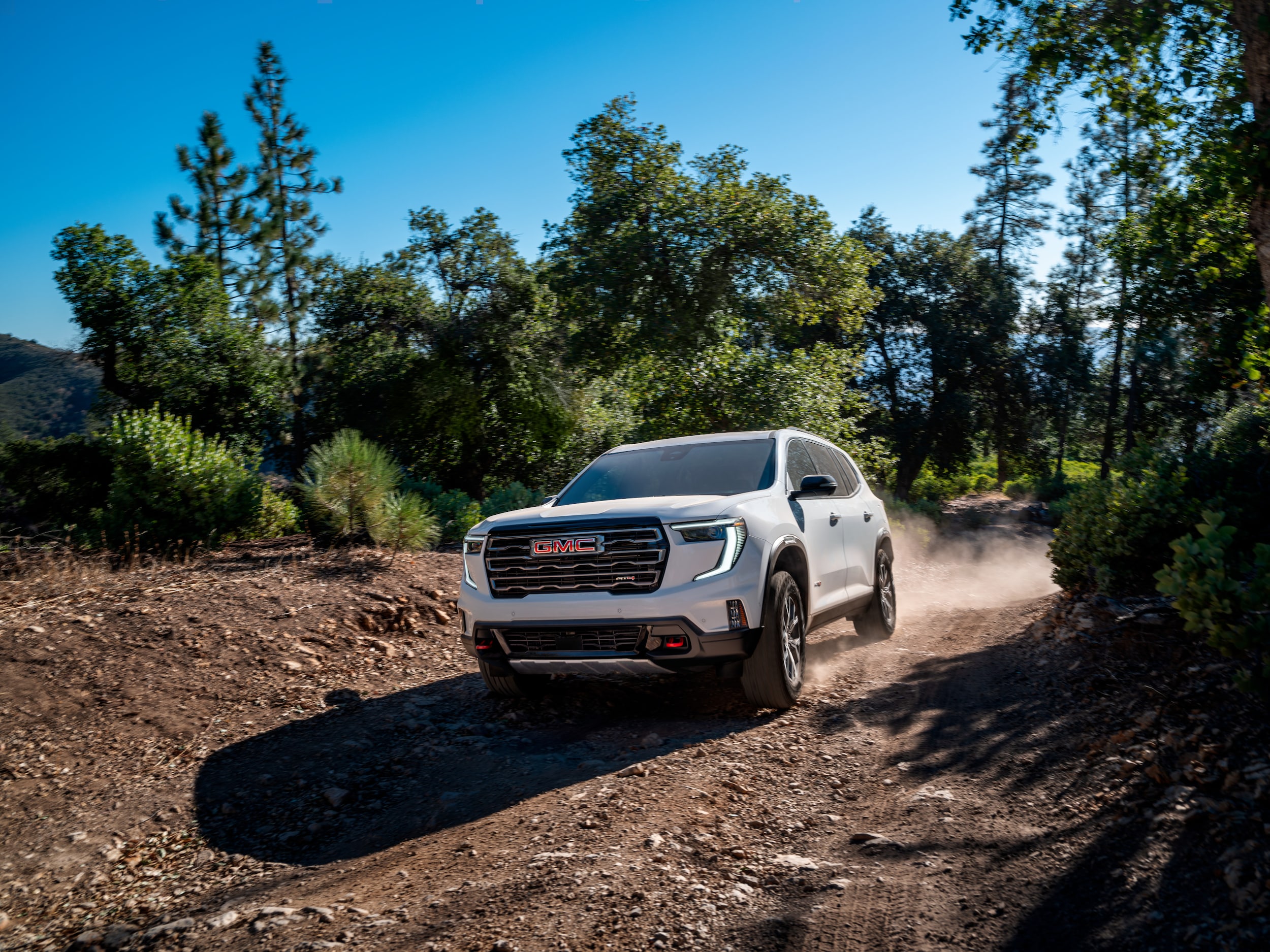 2024 GMC Acadia driving on dirt road
