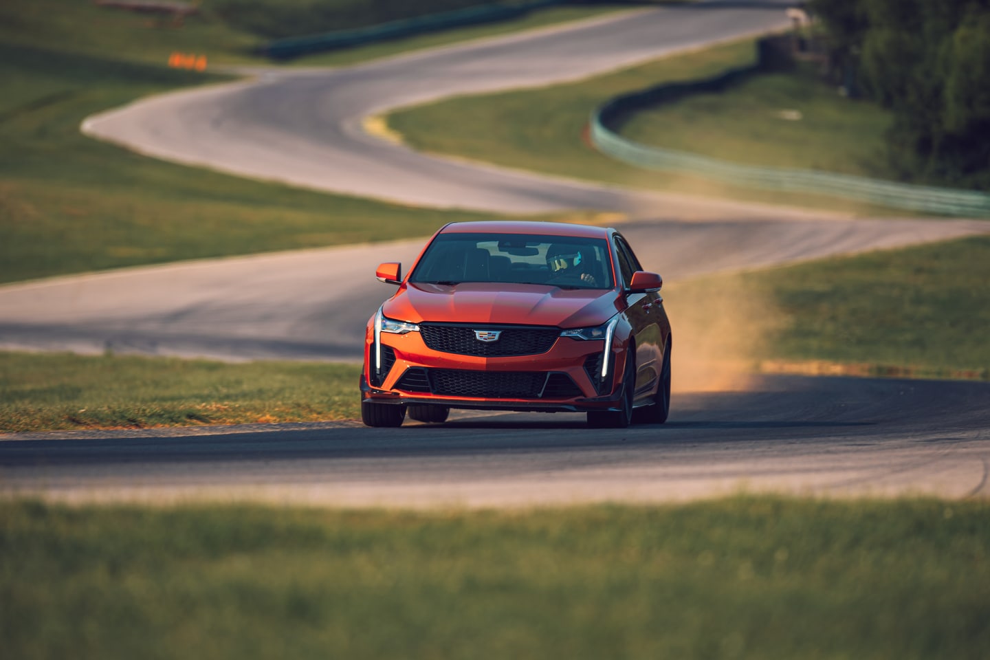 Orange Cadillac CT4 on winding road