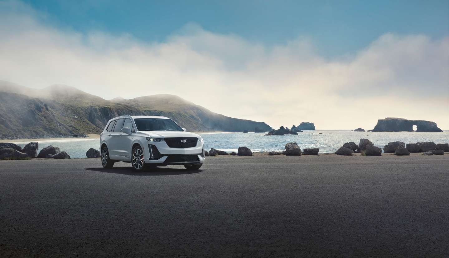 White Cadillac XT6 by the water