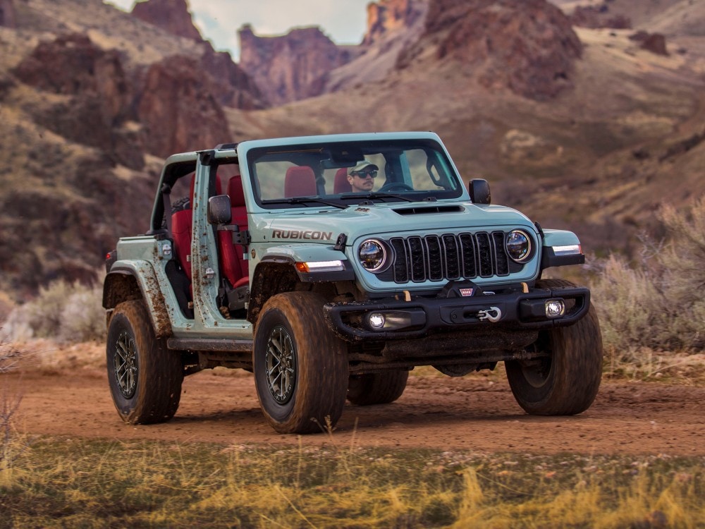  Jeep Wrangler driving on dirt road with doors off