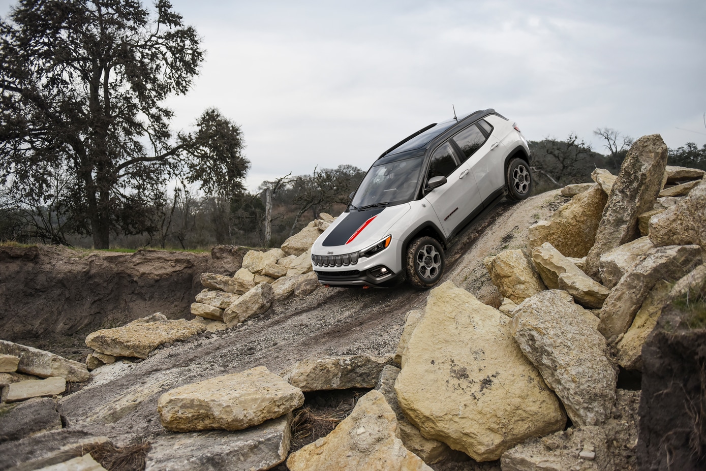  2026 Jeep Compass driving on steep dirt terrain