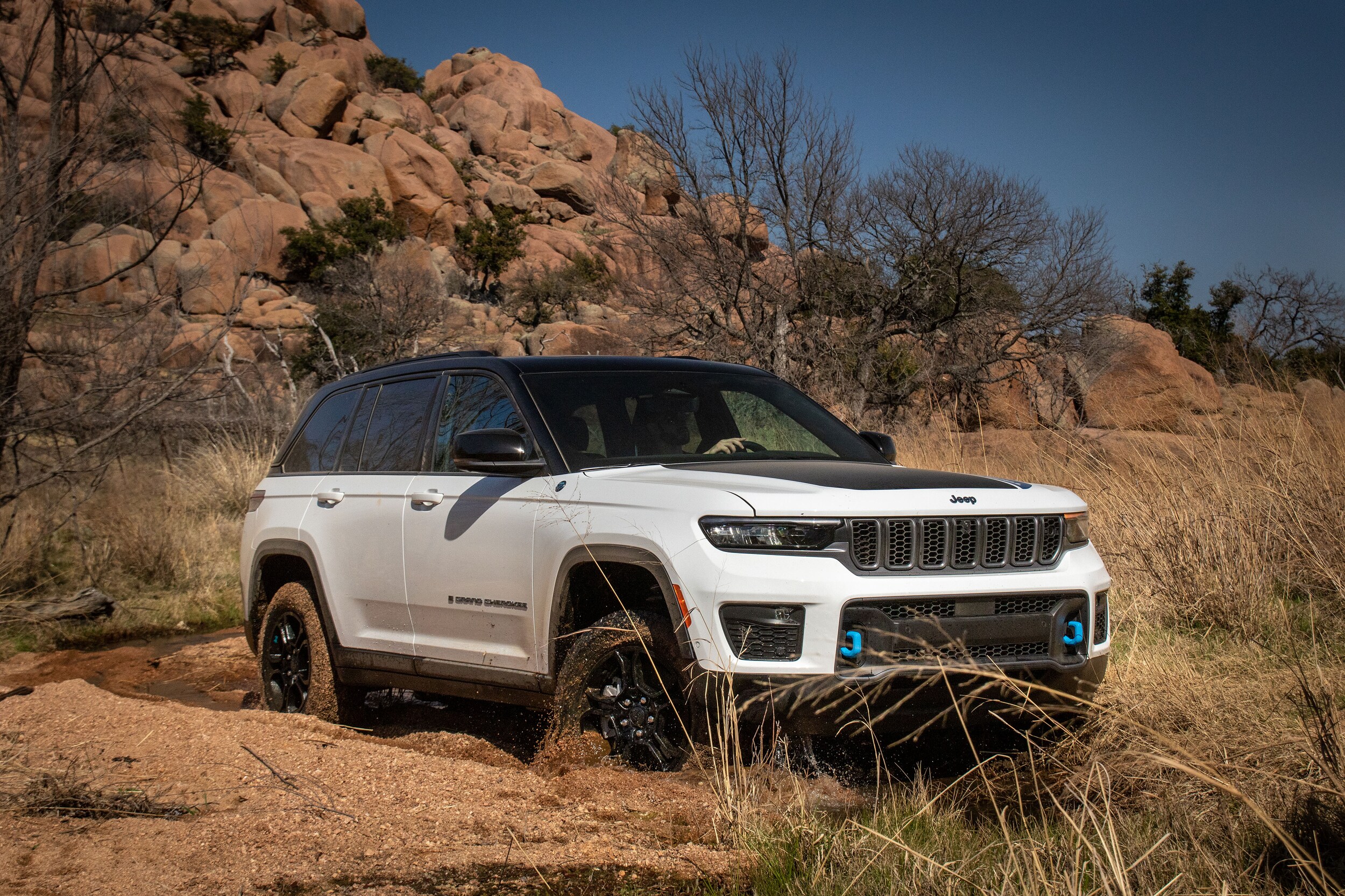 White Jeep Grand Cherokee 4xe parked on dirt road