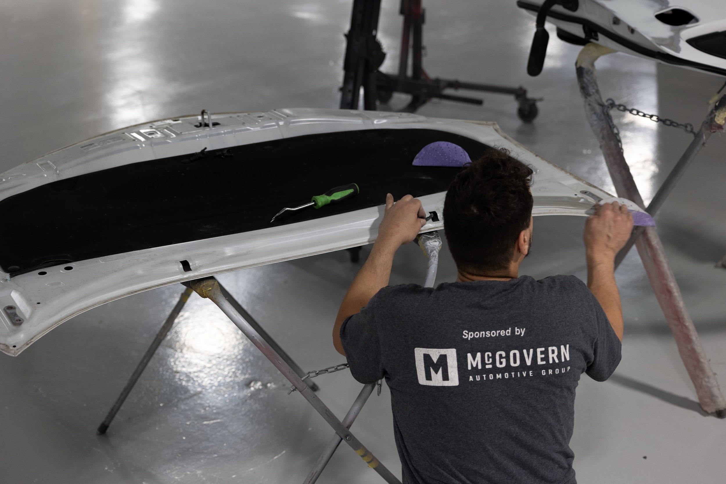  Person cheerfully signing documents.