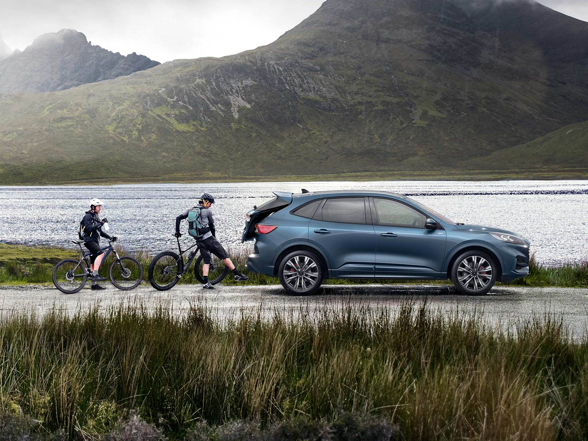 Couple on bikes with a Ford Escape