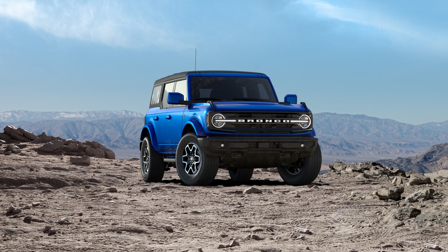 Blue Ford Bronco on rocky ridge