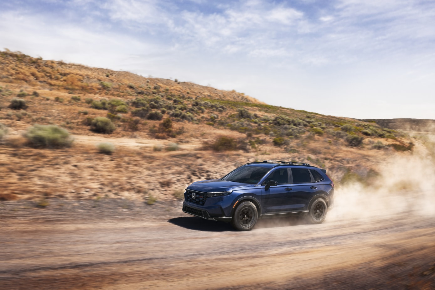 Honda CR-V driving on dirt road