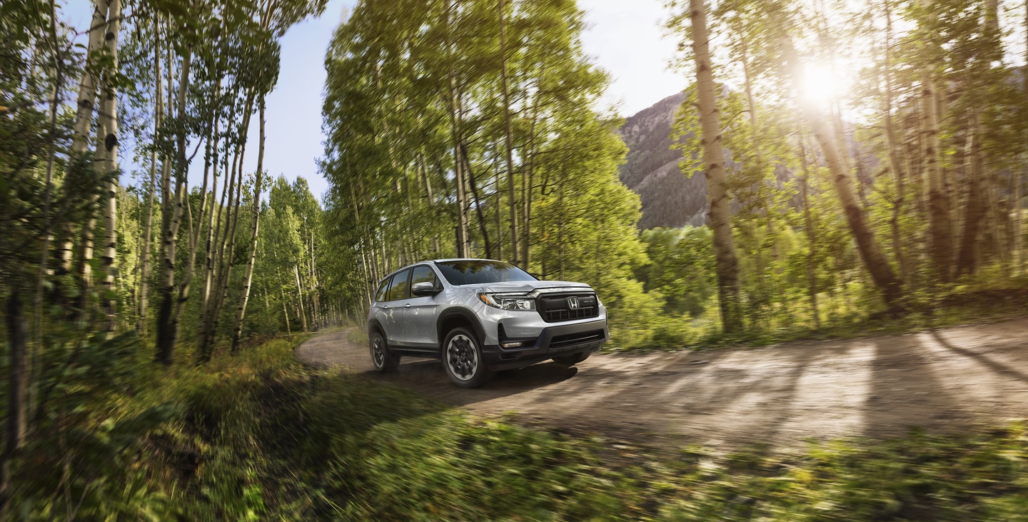 Honda Passport driving in a stream