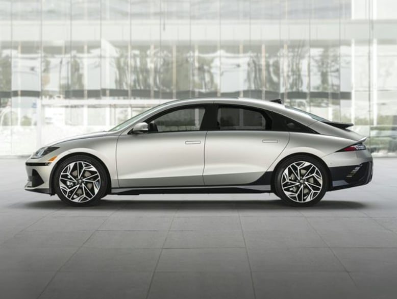 Silver Hyundai IONIQ 6 parked by building