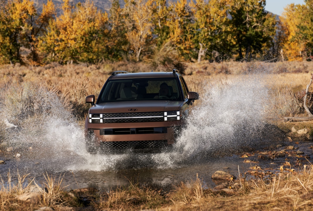 Brown Hyundai Santa Fe driving through deep water