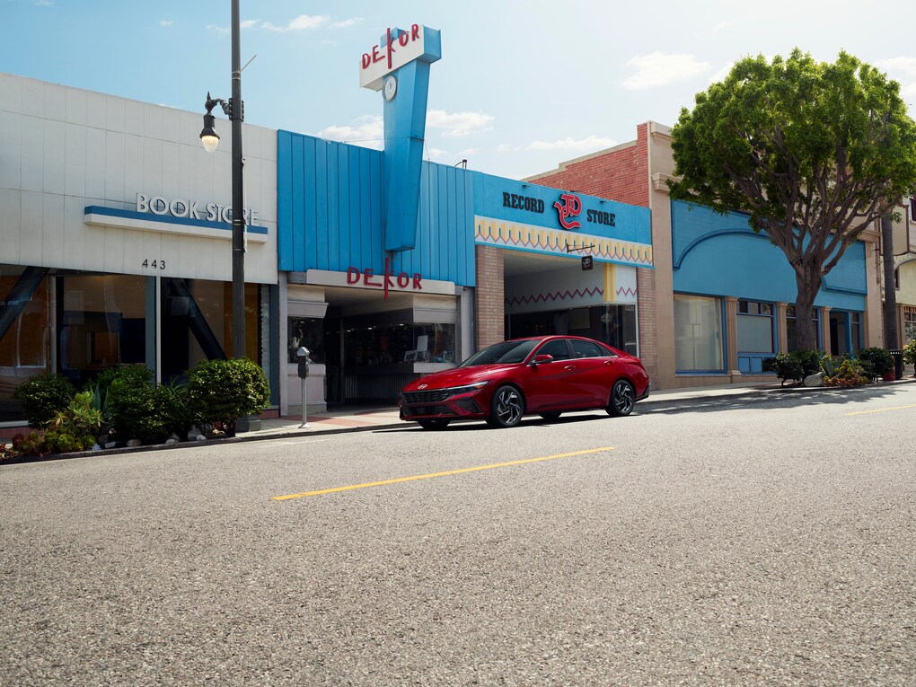 Red Hyundai Elantra parked by art gallery