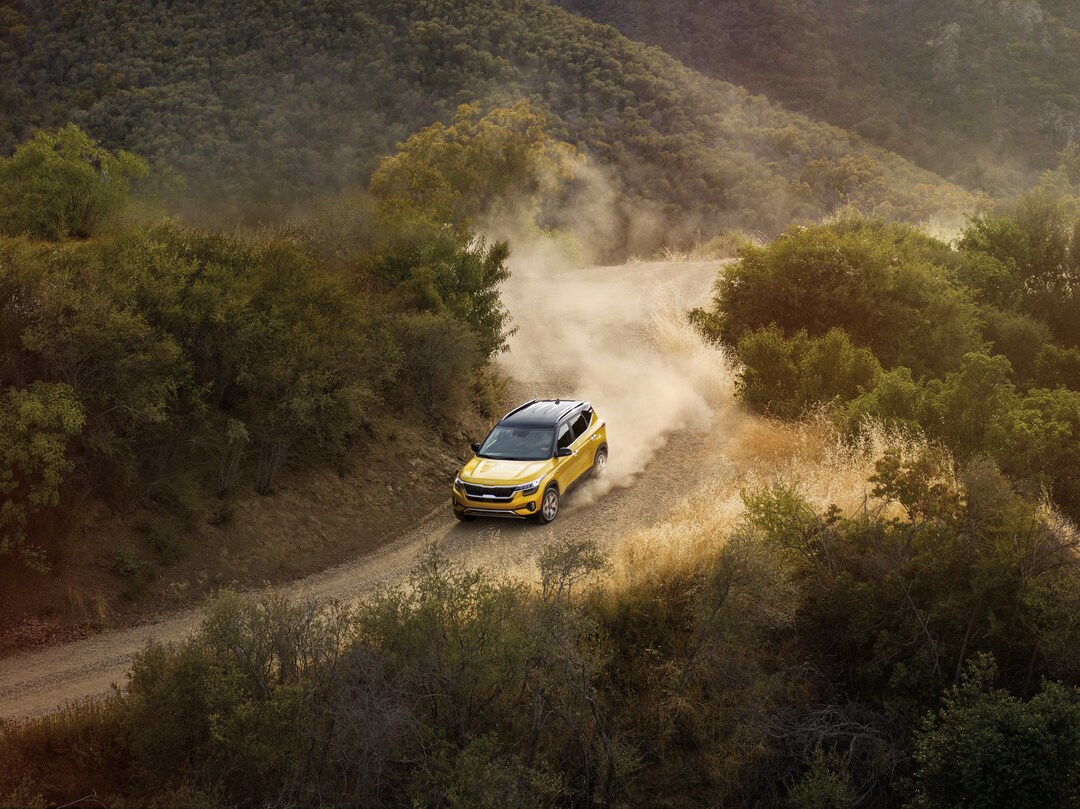 Kia Seltos driving on dirt trail
