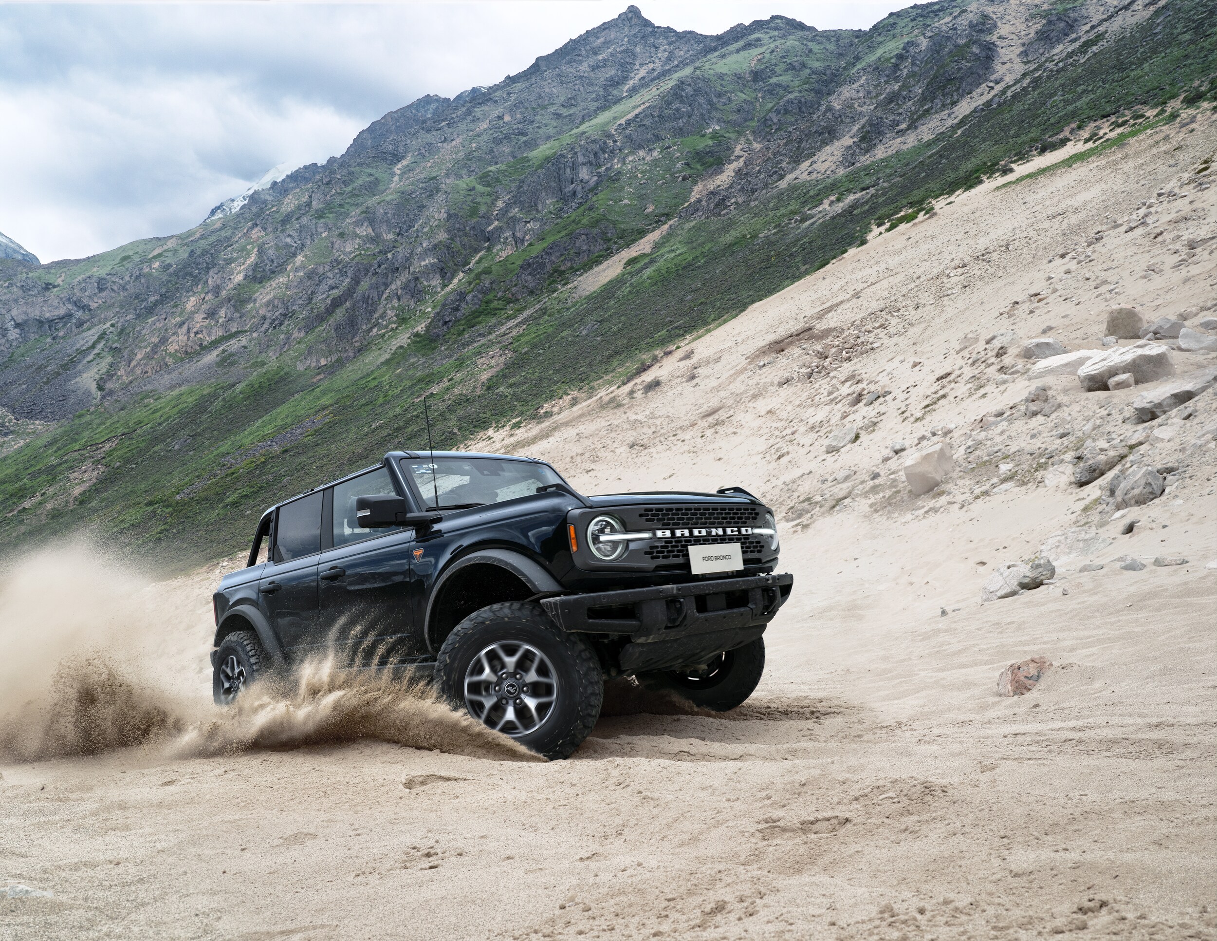 Ford Bronco driving up dirt hill
