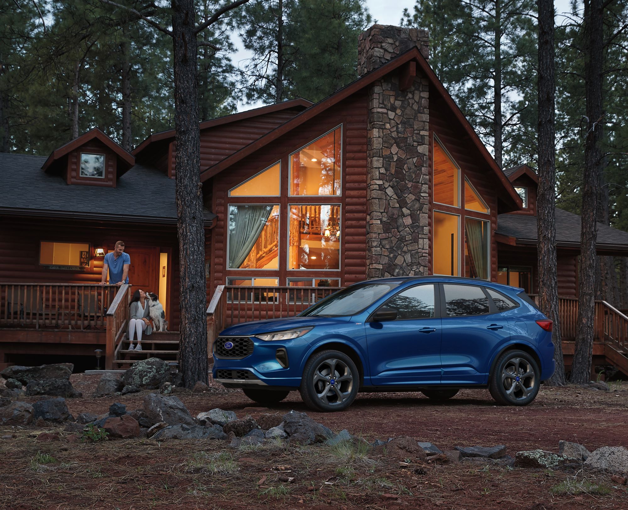 Blue Ford Escape at cabin in the woods