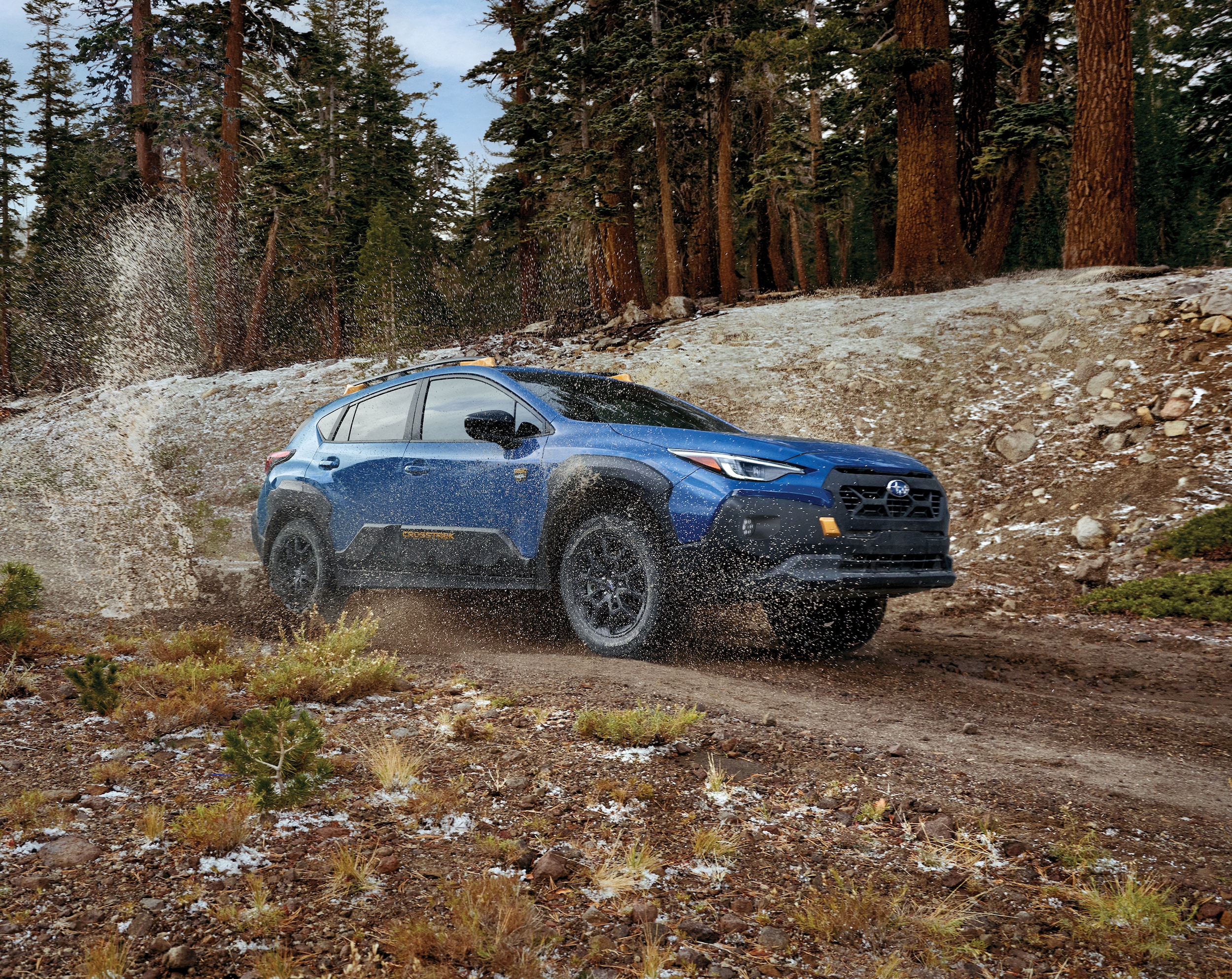 Subaru Crosstrek Wilderness driving on muddy trail