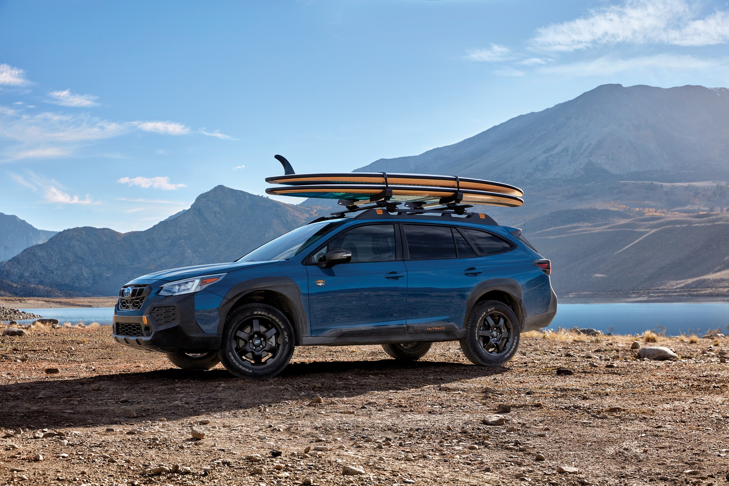 Subaru Outback Wilderness with surfboards on roof rack