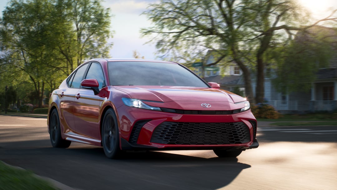  2026 Toyota Camry driving through neighborhood