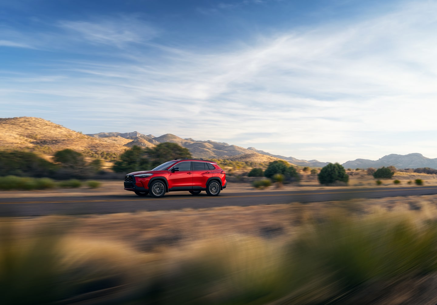  Red 2026 Toyota Corolla Cross on the road