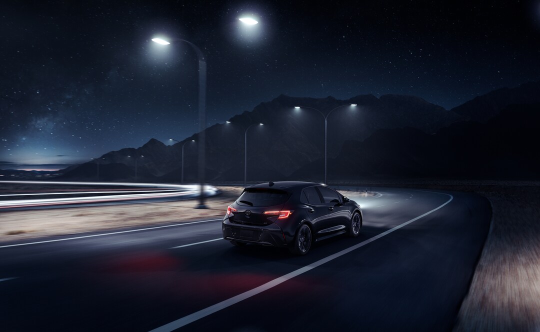 Toyota Corolla Hatchback on the road at night