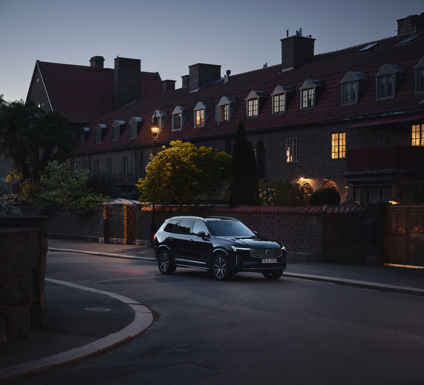  2026 Volvo XC90 Plug-In Hybrid driving in neighborhood