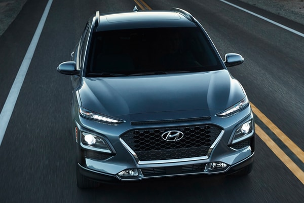 2019 Sonic Silver Hyundai Kona driving down the road