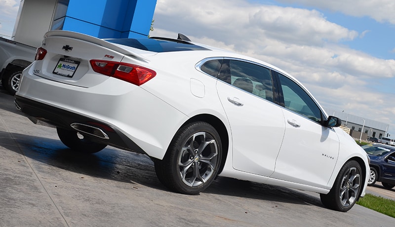 2019 Summit White Chevy Malibu RS rear tailgate parked in front of building