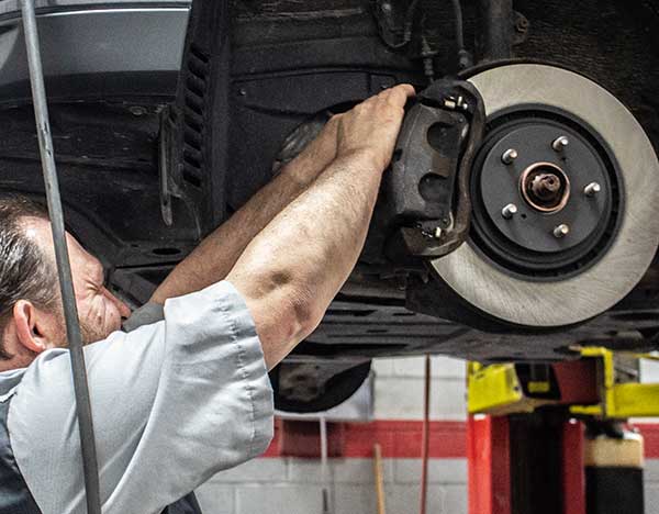 service technician working on tire rotator