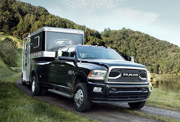 Ram 3500 hauling a trailer on a hill
