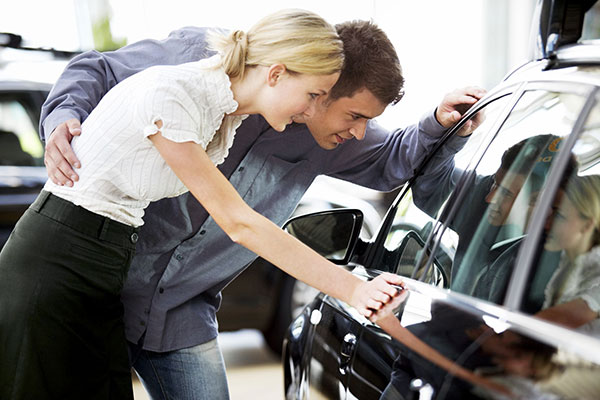 Couple looking at a car