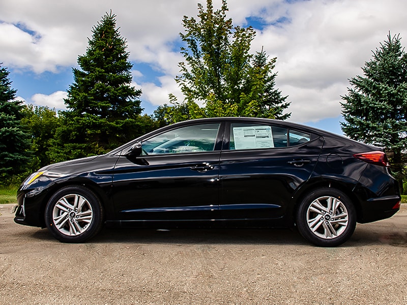 2020 Black Hyundai Elantra parked next to trees