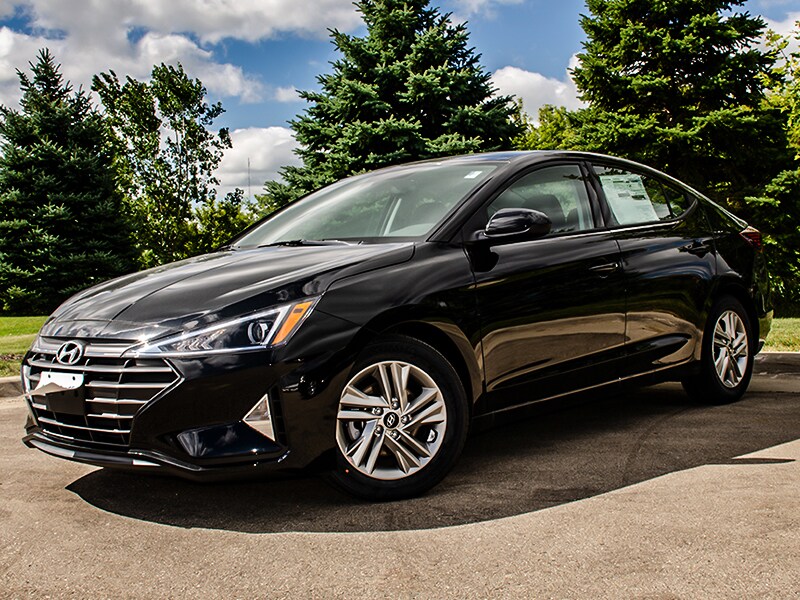 2020 Black Hyundai Elantra parked next to trees
