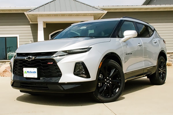 2019 Graphite Metallic Chevy Blazer driving down the street 