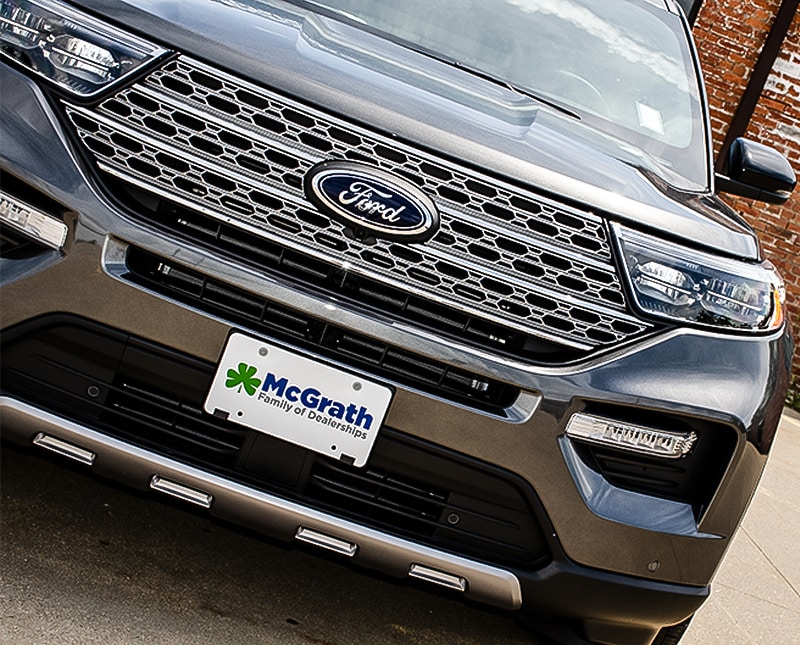 2020 Gray Ford Explorer front grille parked in front of trees