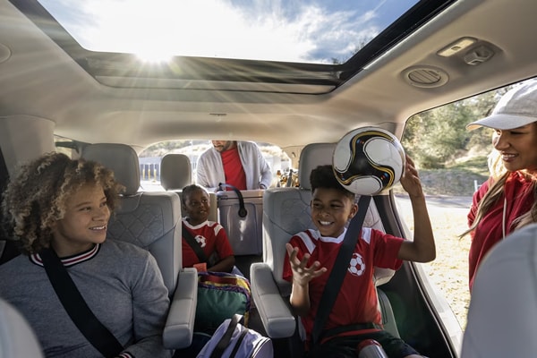 2025 Ford Explorer Interior seating with a family packing up their kids for a soccer game