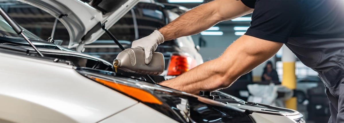 pouring oil into vehicle