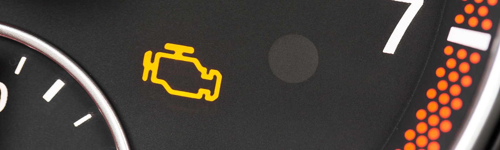 photo of a vehicle dashboard with the check engine light on