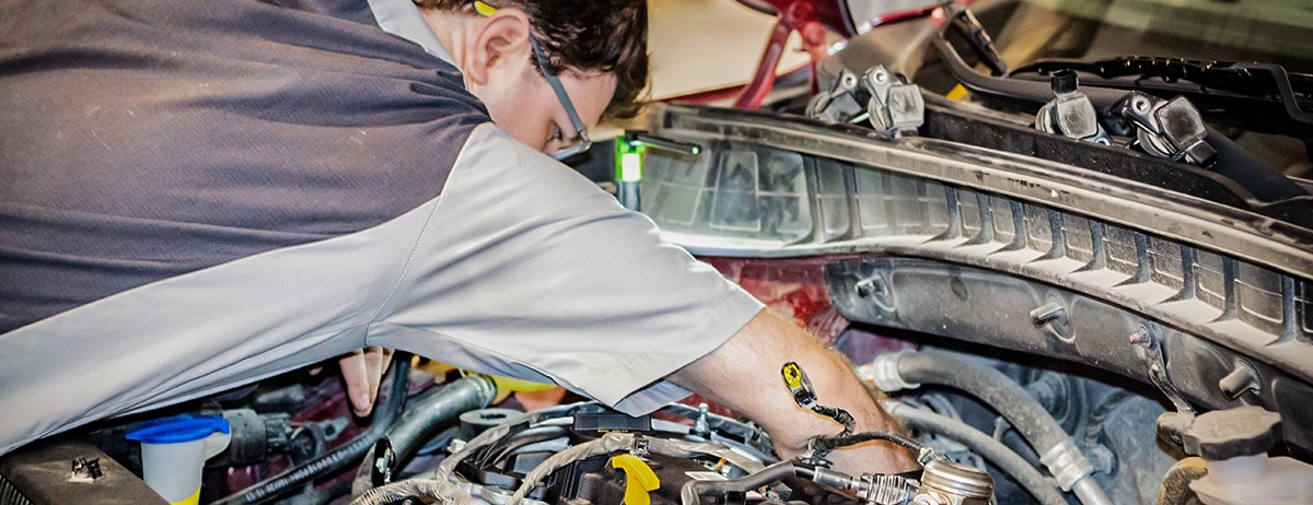 McGrath Kia Service Tech working on a vehicle