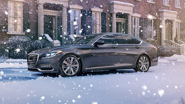 Grey 2019 G80 driving through the snow