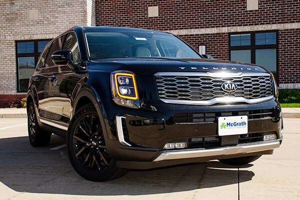 2020 black Kia Telluride parked next to building