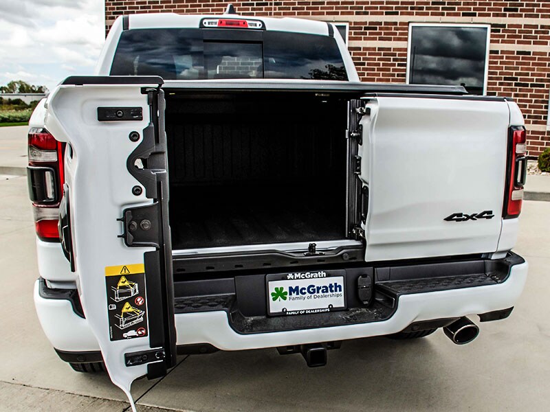 2021 Ram 1500 parked next to building showing available 60/40 Split Swing-Away Doors