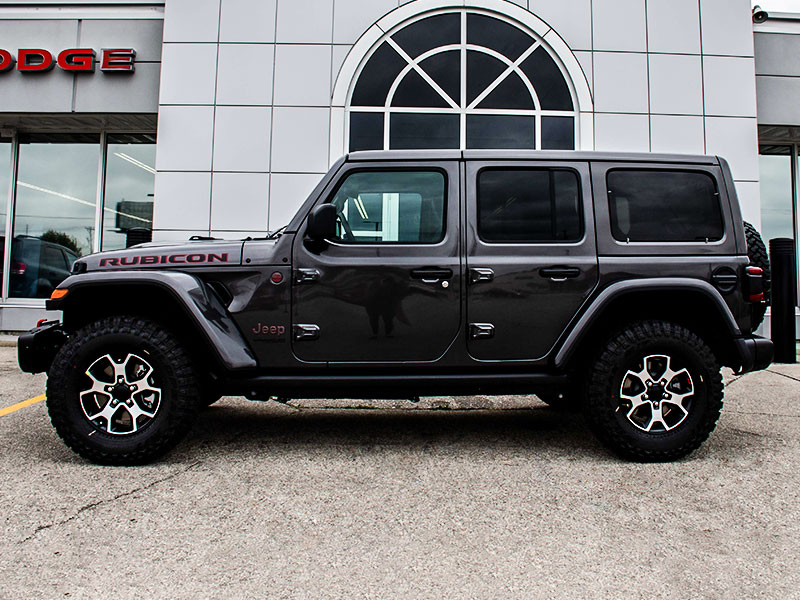 2021 Jeep Wrangler parked next to Chrysler Jeep Dodge Ram