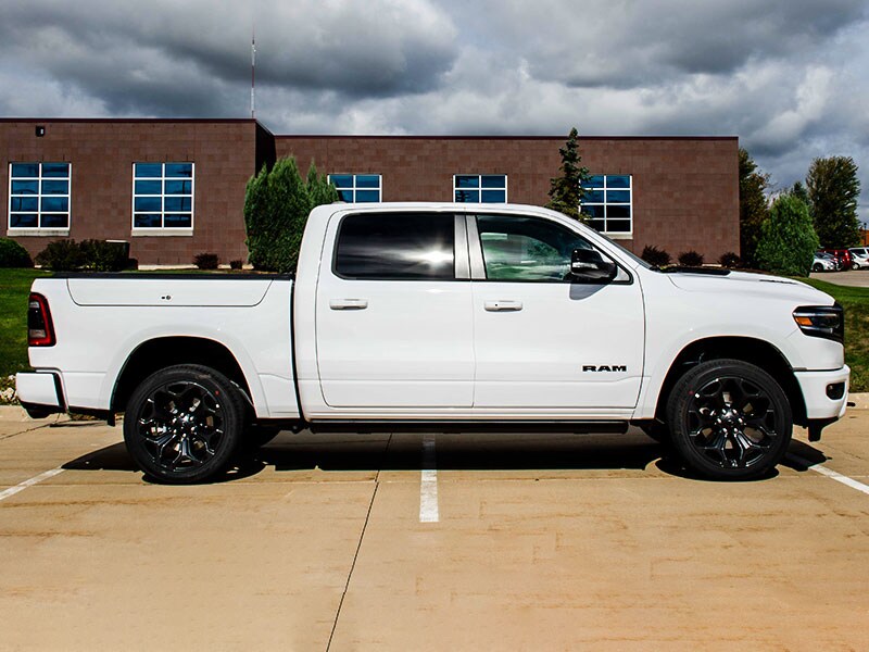 2021 Ram 1500 side exterior parked next to building