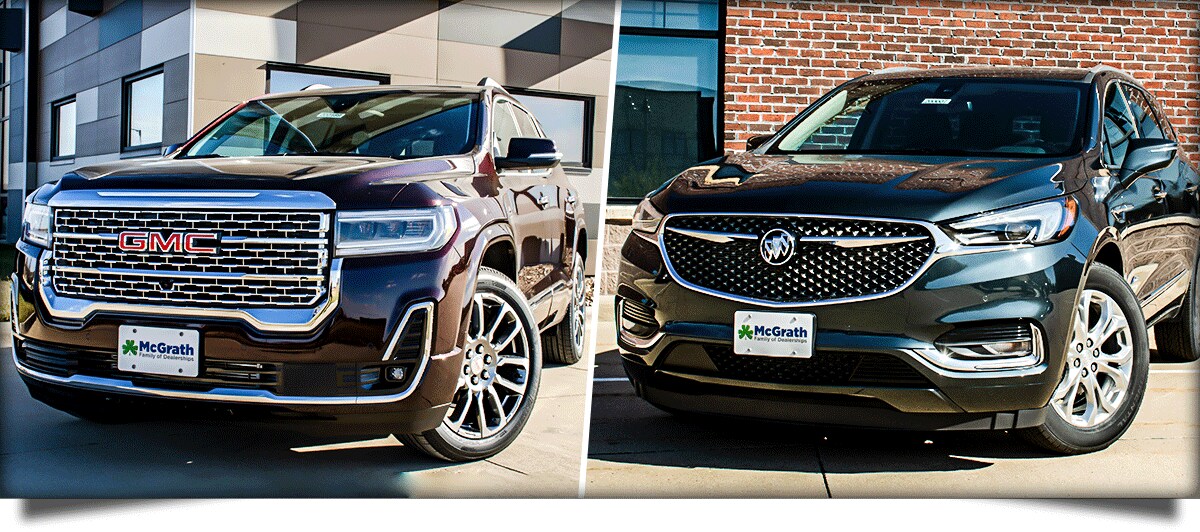 2020 GMC Acadia and Buick Enclave parked next to buildings side by side