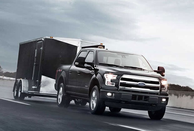 Black Ford F-150 hauling a trailer