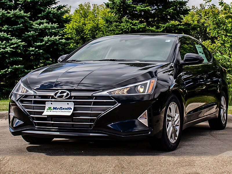 2020 Black Hyundai Elantra parked next to trees