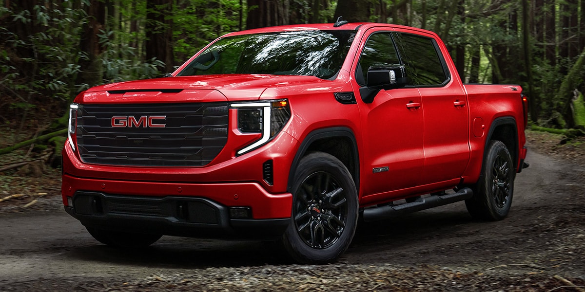 GMC sierra 1500 driving through the woods