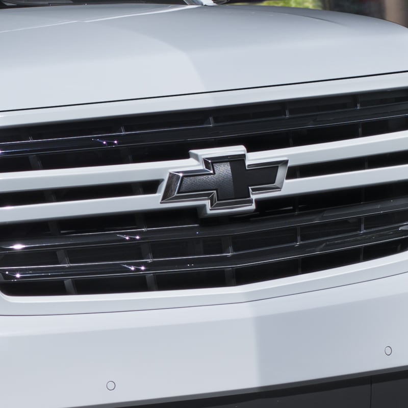 Tahoe Premier in Summit White Gloss Black sport grille featuring a body-color surround and black bowtie emblem
