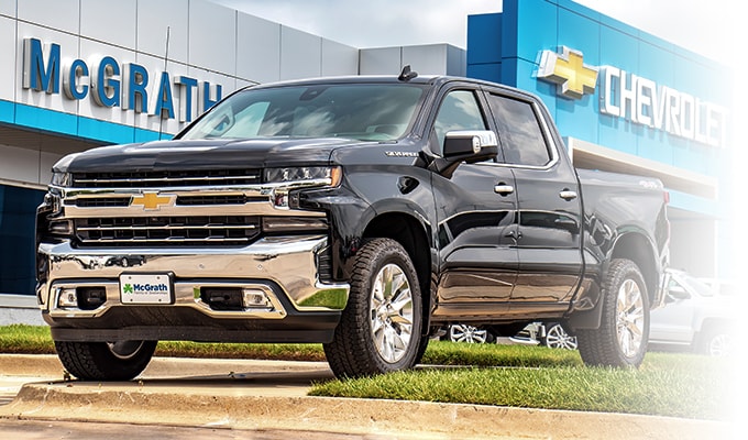Chevy Silverado in black in front of the dealership