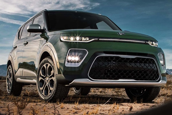 2020 Kia Soul in the desert parked with its lights on