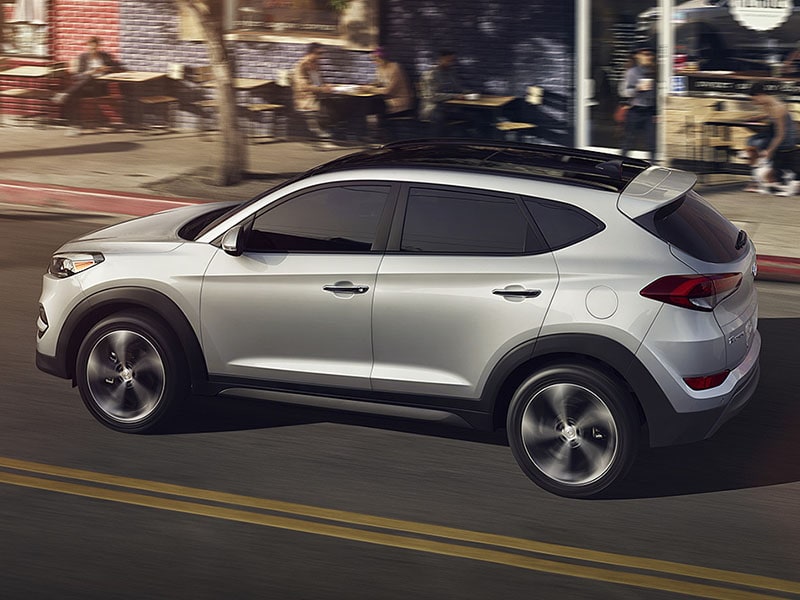 Silver 2017 Hyundai Tucson Driving down the road