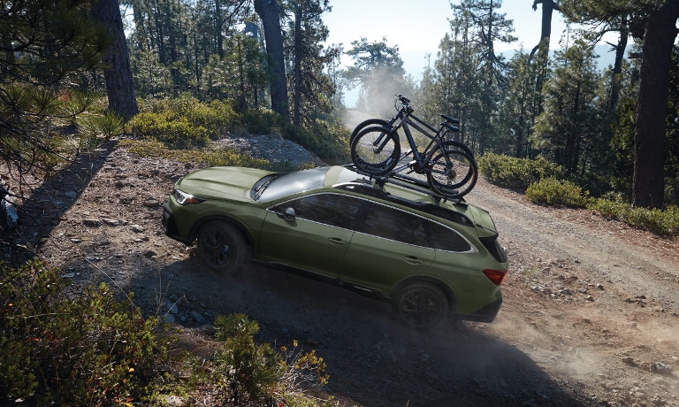 Green 2020 Subaru Outback on cliff